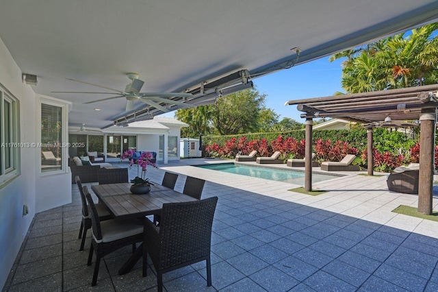 view of patio / terrace with outdoor dining space, an outdoor living space, a ceiling fan, and a fenced in pool