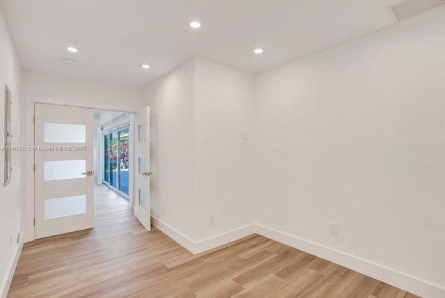 spare room featuring recessed lighting, baseboards, visible vents, and light wood finished floors