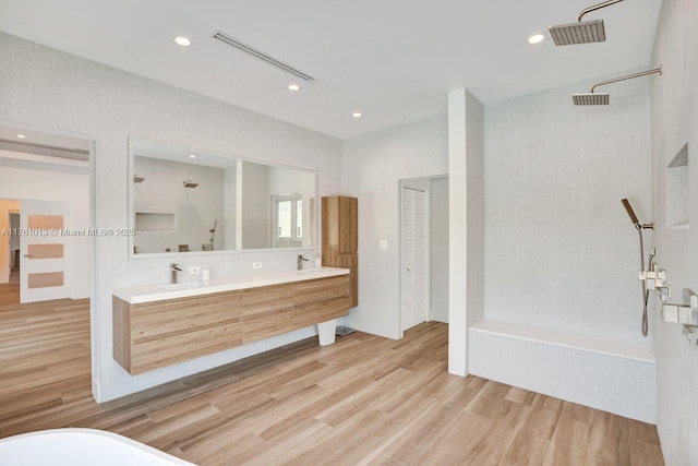 full bath with wood finished floors, visible vents, a bathing tub, and a shower