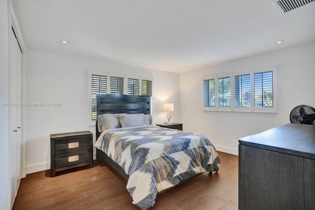 bedroom with visible vents, recessed lighting, baseboards, and wood finished floors