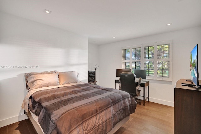 bedroom with recessed lighting, baseboards, and light wood finished floors