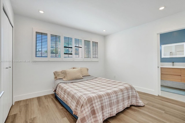 bedroom featuring recessed lighting, light wood-type flooring, and baseboards