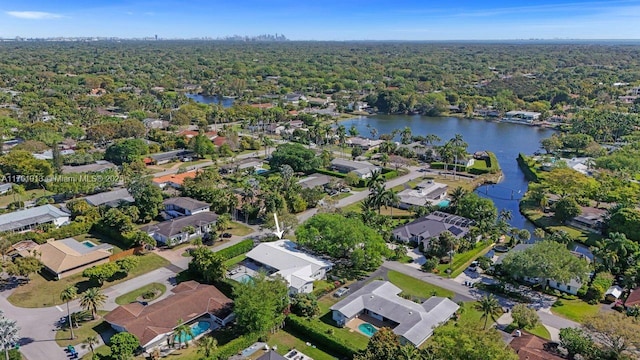 bird's eye view with a residential view, a water view, and a wooded view