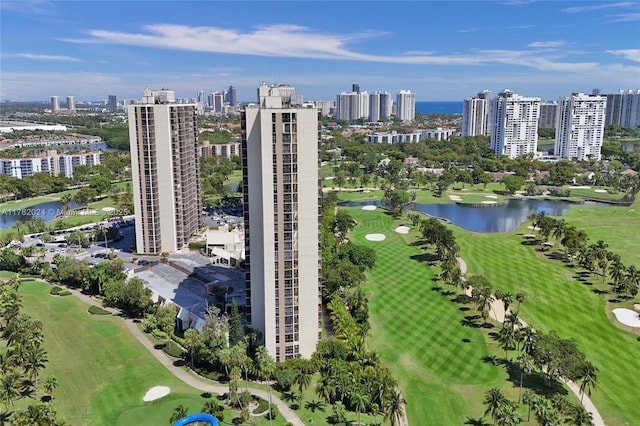 bird's eye view with a view of city, view of golf course, and a water view