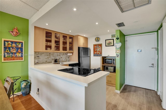 kitchen featuring a sink, visible vents, appliances with stainless steel finishes, and light wood-style flooring