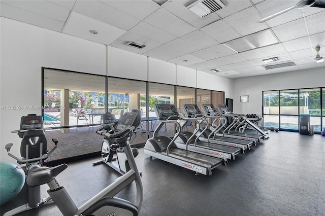 exercise room with a drop ceiling and visible vents