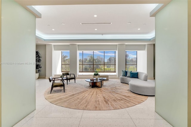 sitting room with recessed lighting and a tray ceiling