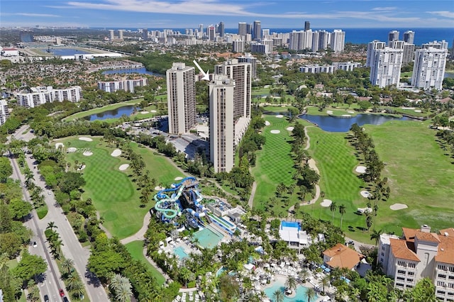 birds eye view of property with a water view, a view of city, and golf course view