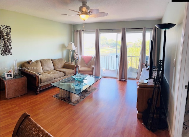 living room featuring a wealth of natural light, wood finished floors, and ceiling fan