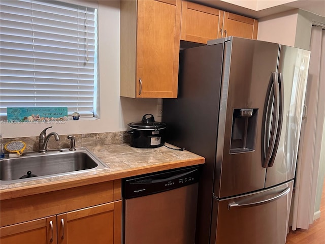 kitchen featuring a sink, light countertops, and stainless steel appliances