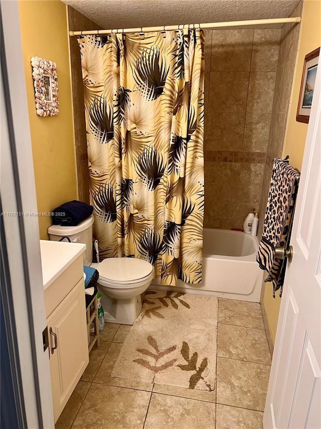 bathroom featuring tile patterned floors, toilet, a textured ceiling, shower / tub combo, and vanity