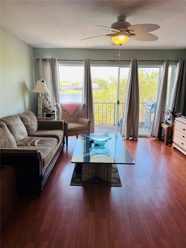 living area with plenty of natural light, ceiling fan, and wood finished floors