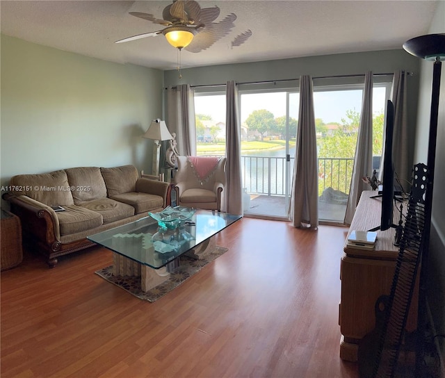 living room with a ceiling fan and wood finished floors