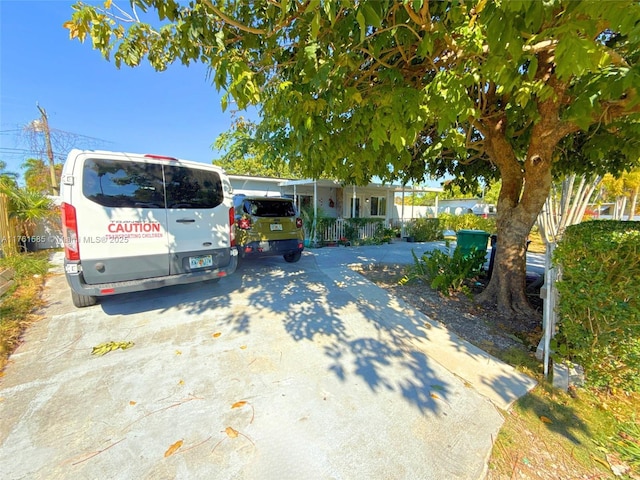 view of front of home with a carport, covered porch, and driveway