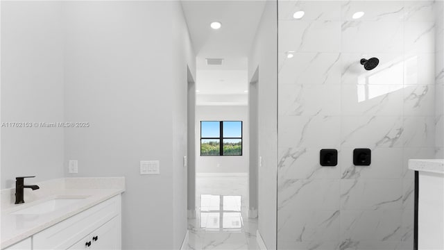 bathroom featuring a marble finish shower, visible vents, recessed lighting, marble finish floor, and vanity