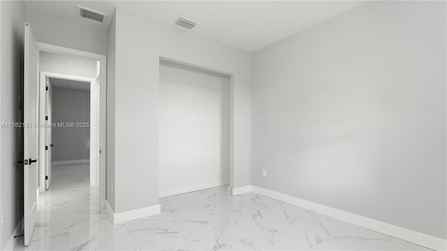 unfurnished bedroom featuring visible vents and marble finish floor