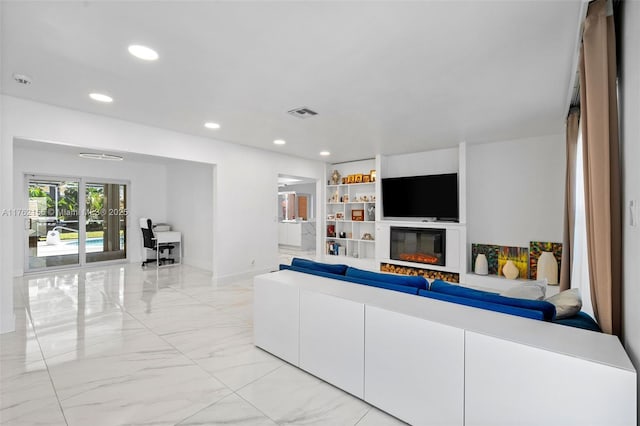 living room with recessed lighting, marble finish floor, baseboards, and a glass covered fireplace