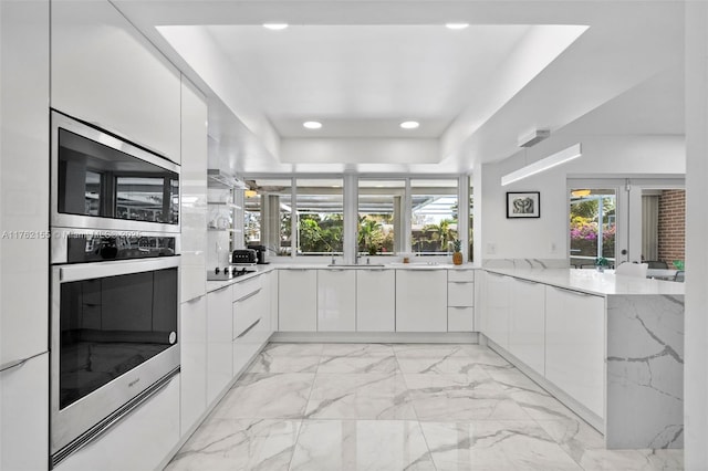 kitchen with recessed lighting, marble finish floor, modern cabinets, and white cabinets