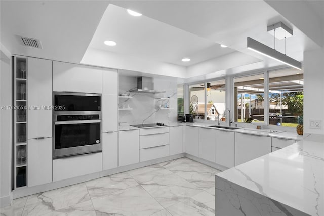 kitchen with modern cabinets, visible vents, appliances with stainless steel finishes, and a sink