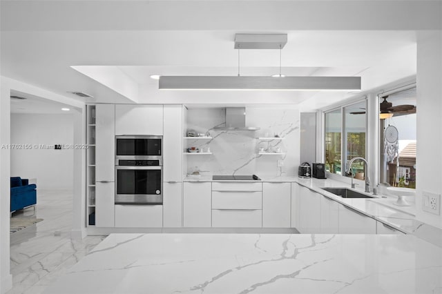 kitchen featuring a sink, light stone counters, stainless steel appliances, white cabinetry, and modern cabinets