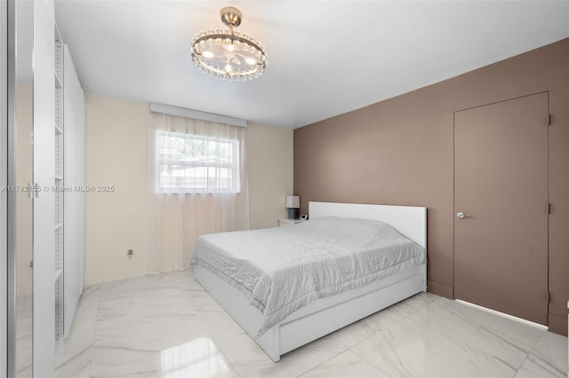 bedroom with a notable chandelier and marble finish floor