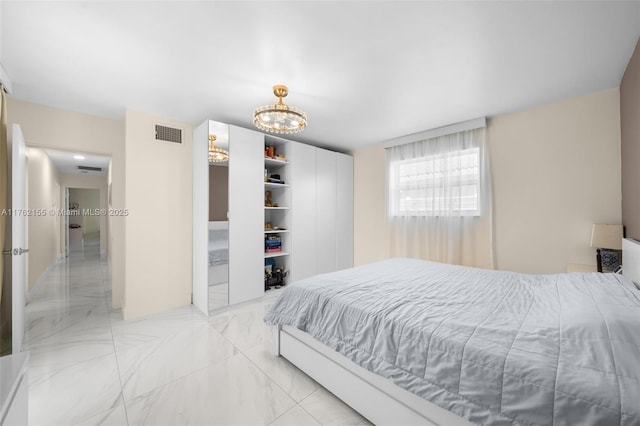 bedroom featuring visible vents and marble finish floor