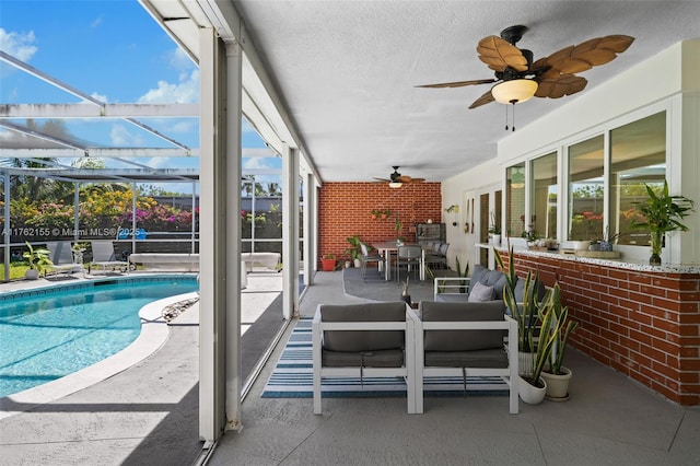 outdoor pool with outdoor dining space, a lanai, a patio area, and ceiling fan