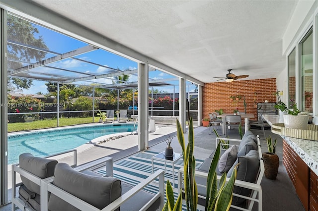 view of swimming pool with a fenced in pool, glass enclosure, an outdoor hangout area, a patio, and a ceiling fan