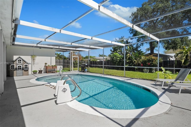 view of pool featuring a patio area, a fenced in pool, glass enclosure, and fence