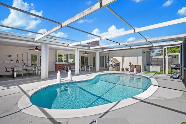 outdoor pool featuring a lanai, ceiling fan, and a patio