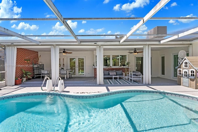 outdoor pool featuring ceiling fan, a lanai, french doors, an outdoor hangout area, and a patio area