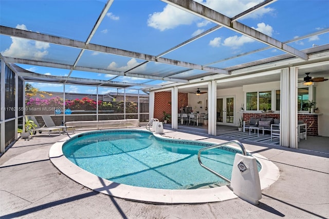 outdoor pool with ceiling fan, french doors, a lanai, and a patio area