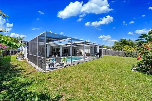 back of house featuring a fenced in pool, a lanai, a lawn, a fenced backyard, and a patio