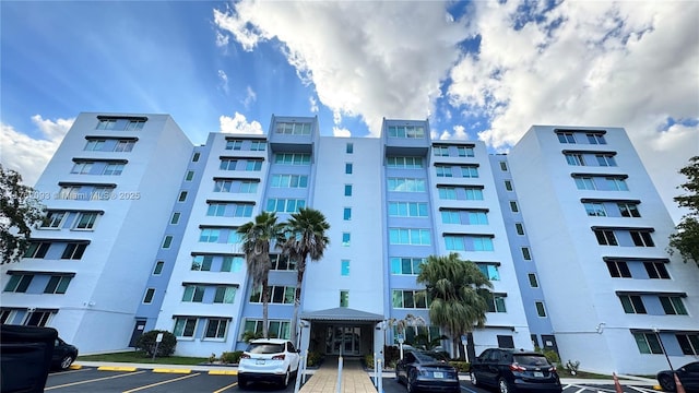 view of building exterior with uncovered parking