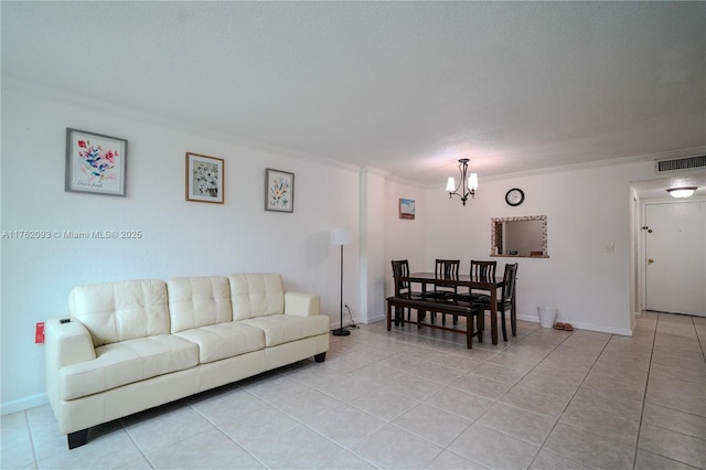 living room with light tile patterned floors, baseboards, visible vents, an inviting chandelier, and crown molding