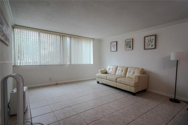 tiled living area with crown molding, baseboards, and a textured ceiling