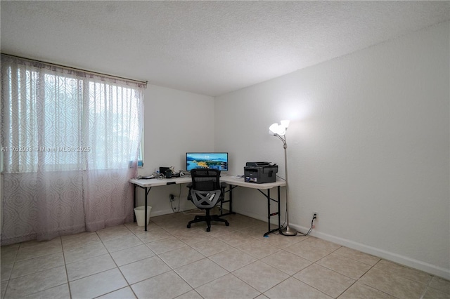 office area with light tile patterned floors, baseboards, and a textured ceiling