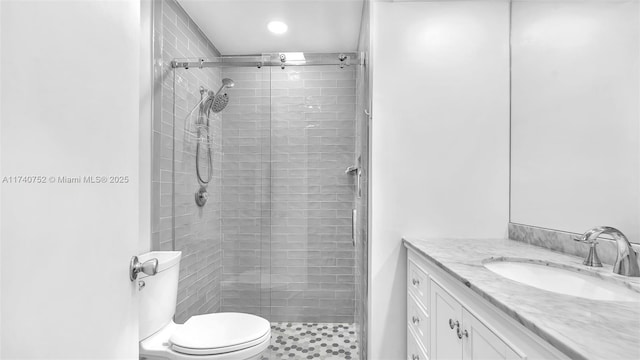 full bath featuring a shower stall, vanity, and toilet