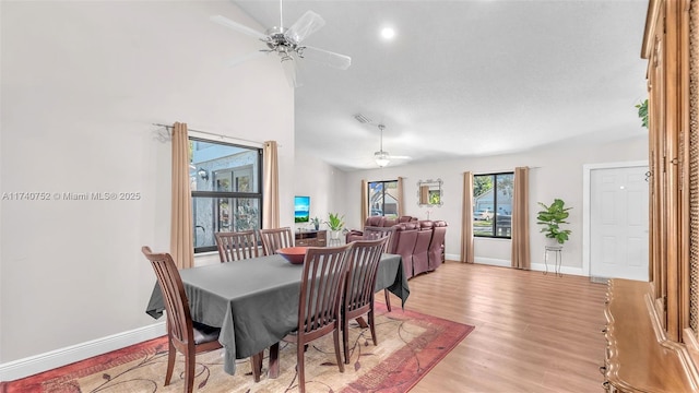 dining space with a ceiling fan, visible vents, baseboards, and light wood-type flooring