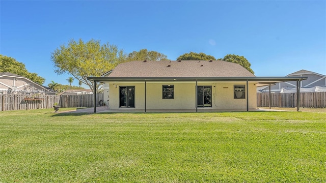 rear view of house featuring a patio area, a lawn, a fenced backyard, and stucco siding