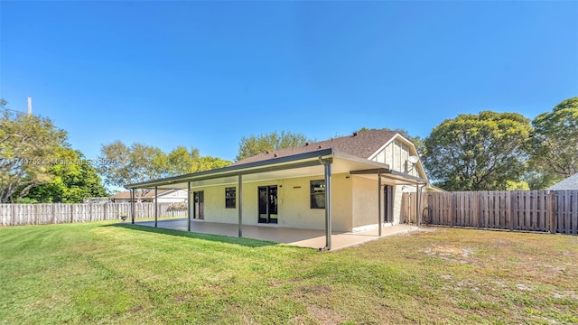 back of house with a patio, a yard, a fenced backyard, and stucco siding