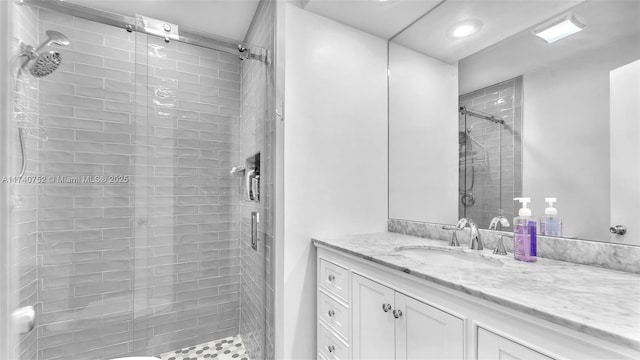 full bath with vanity and a shower stall