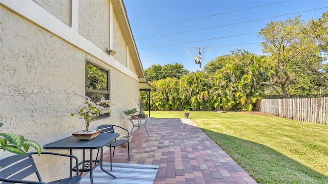 view of patio / terrace featuring fence