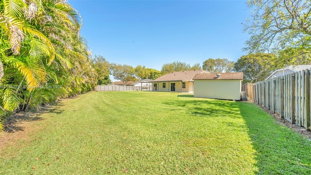 view of yard with a fenced backyard