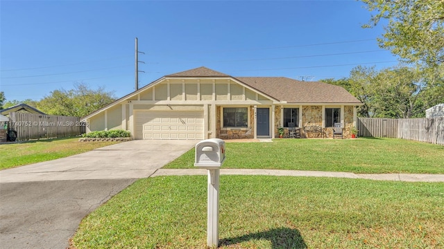 view of front of property with a front lawn, driveway, fence, board and batten siding, and a garage