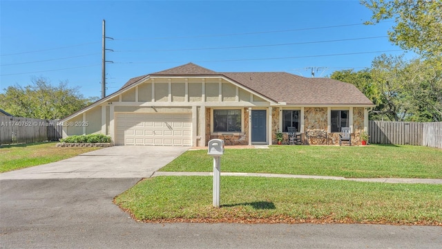 view of front facade with a front lawn, fence, roof with shingles, driveway, and an attached garage