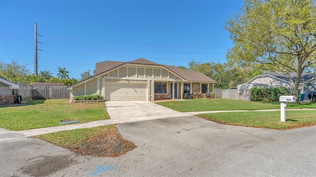 view of front of property featuring a front yard, an attached garage, and fence