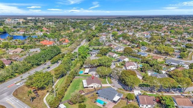 birds eye view of property with a residential view and a water view