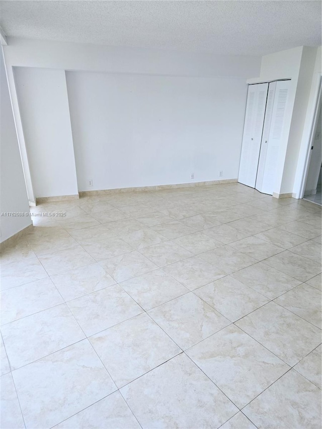 3300 NE 191st St Unit 609, Aventura, FL 33180 - spare room featuring a textured ceiling