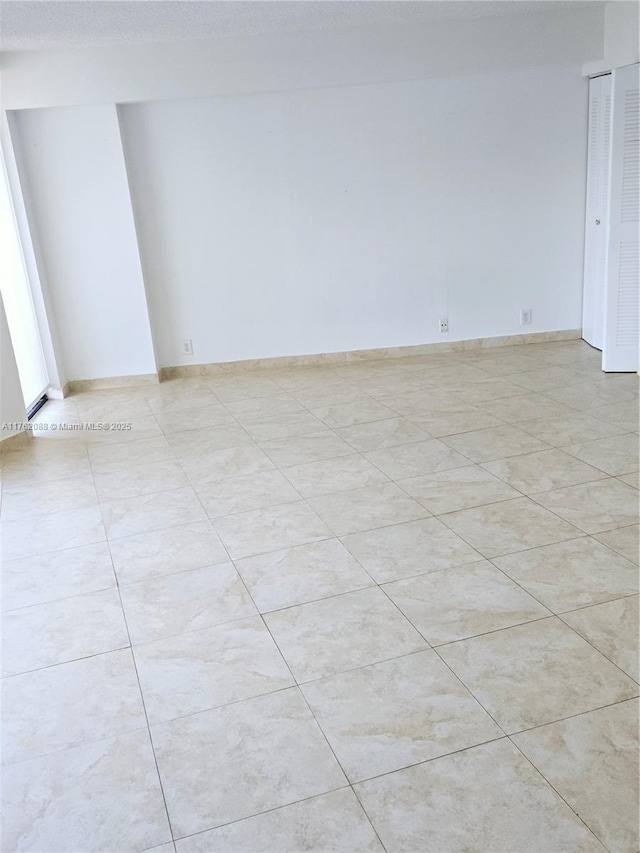3300 NE 191st St Unit 609, Aventura, FL 33180 - unfurnished room with light tile patterned flooring and baseboards